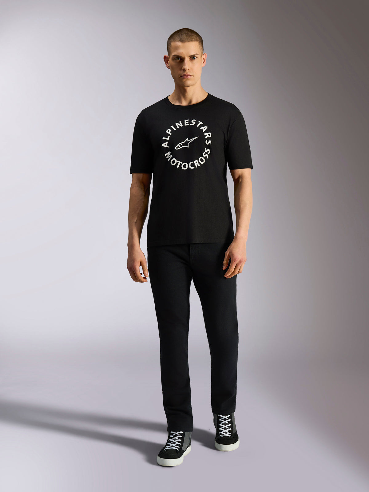 Alpinestars MX CSF Tee, Short Sleeve T-Shirt, Black, White circular Alpinestars Motocross graphic, worn by model with black pants and sneakers, casual motorsport streetwear