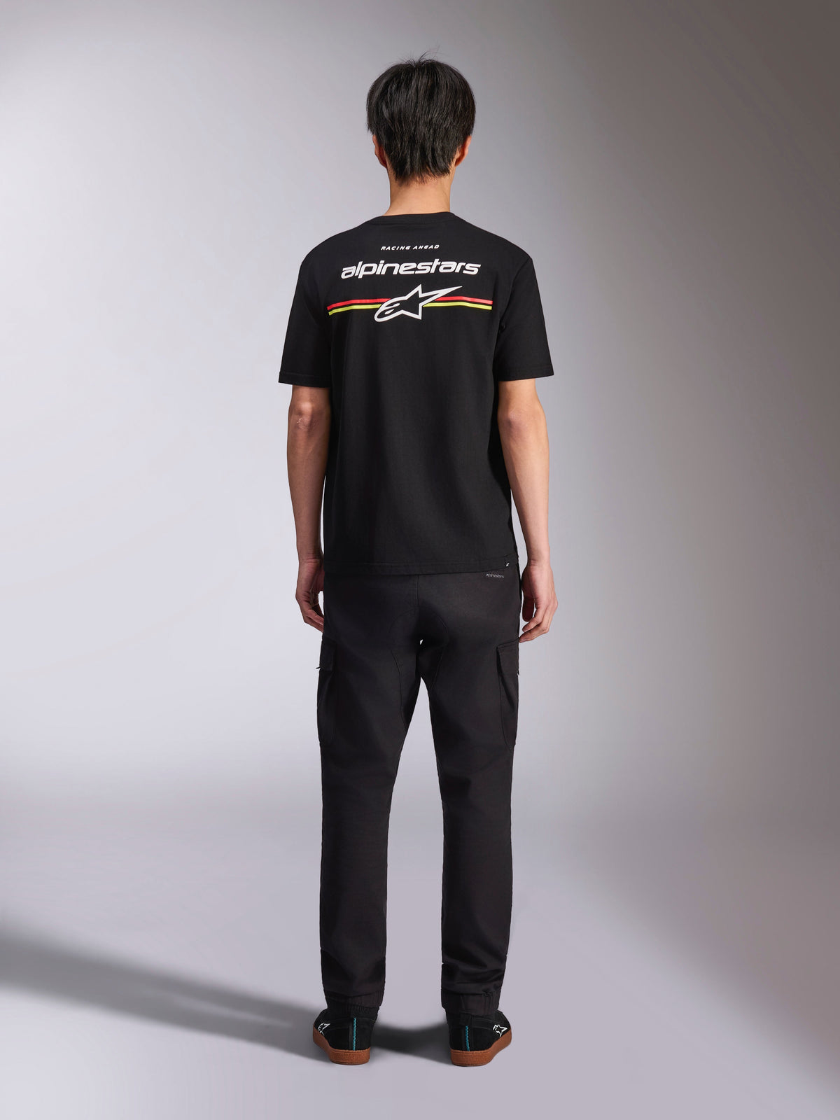 T-shirt Alpinestars Lanes CSF, t-shirt à manches courtes, noir, vue de dos avec logo Alpinestars blanc et rayures rouges et jaunes, vêtement streetwear décontracté