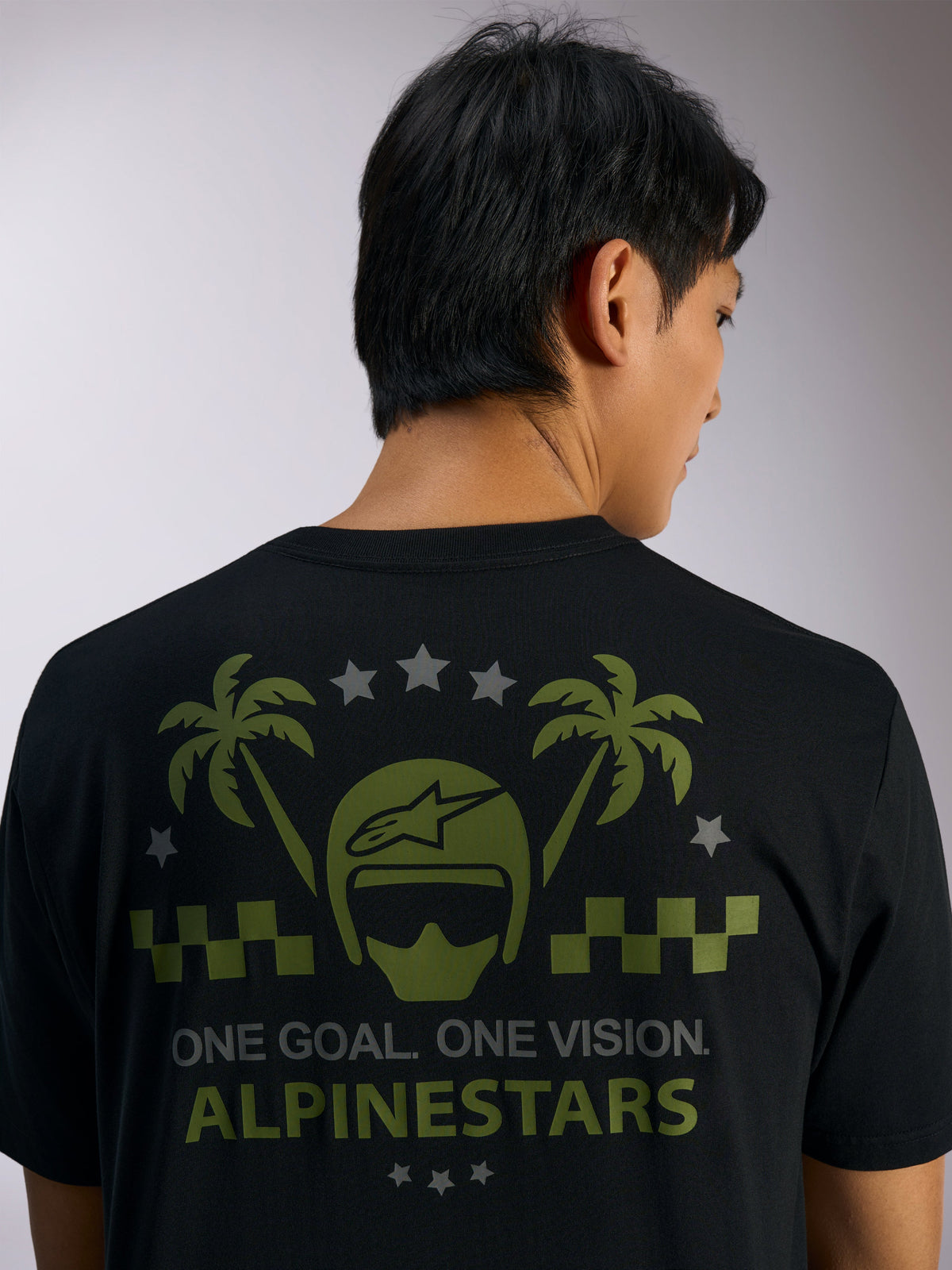 Alpinestars Order CSF Tee, Short Sleeve T-Shirt, Black, back view featuring green helmet and palm tree graphics with gray stars and 'ONE GOAL. ONE VISION. ALPINESTARS' text, Casual Motorsport Streetwear