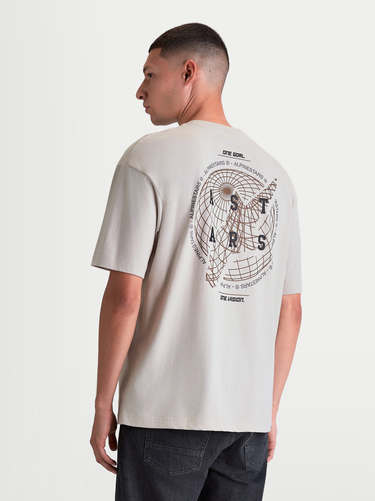 Alpinestars Latitude Oversized CSF Tee, Men's Short Sleeve Sportswear T-shirt, Cement Gray, featuring a large back globe graphic with ASTARS wordmark and One Goal One Vision branding, oversized relaxed fit, 60/40 cotton-poly blend.
