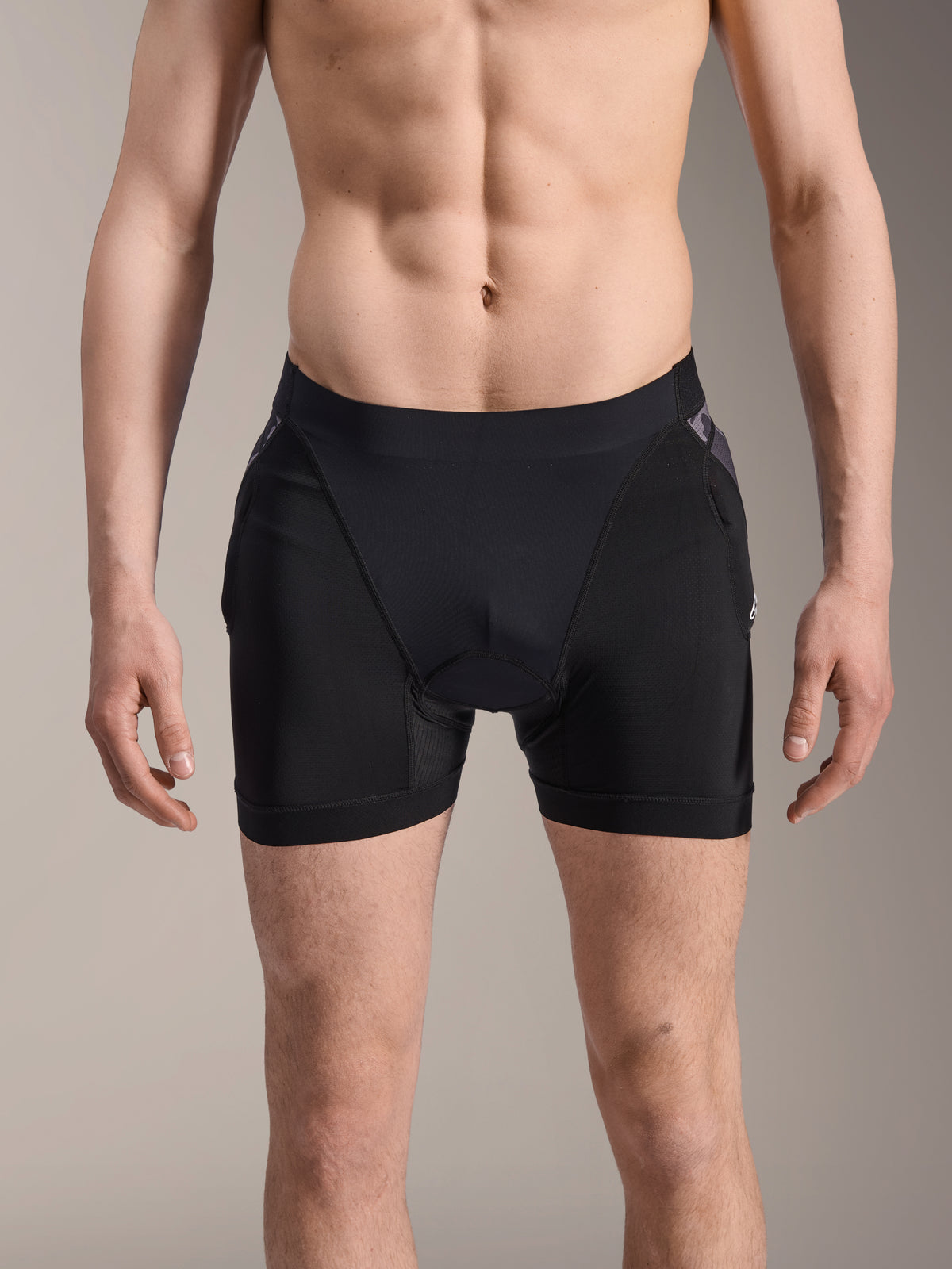 Alpinestars A-Motion Plasma Protection Boxers, MTB Protection Shorts, Black with Black Camo accents, front view on male model, featuring breathable stretch mesh and integrated hip protection for cycling performance.