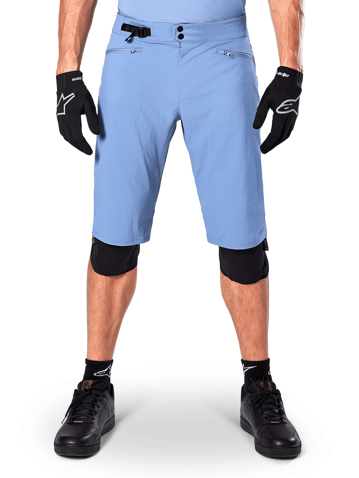 Alpinestars A-Dura Shorts, Infinity Blue mountain bike shorts, worn with black gloves and knee pads, featuring a double snap closure and side waist adjuster, performance cycling gear for MTB
