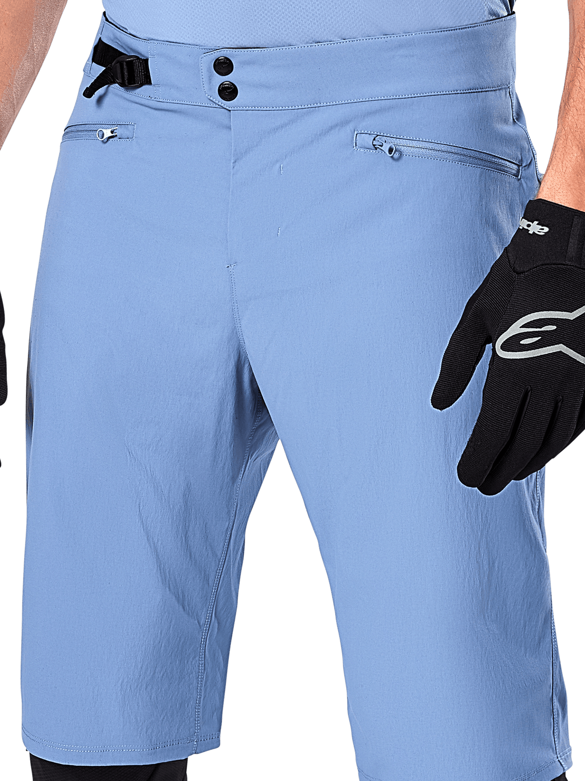 Alpinestars A-Dura Shorts, Infinity Blue mountain bike shorts, close-up of the waist featuring double snap closure, adjustable side cinch, and zippered mesh-lined pockets, worn with a black Alpinestars glove