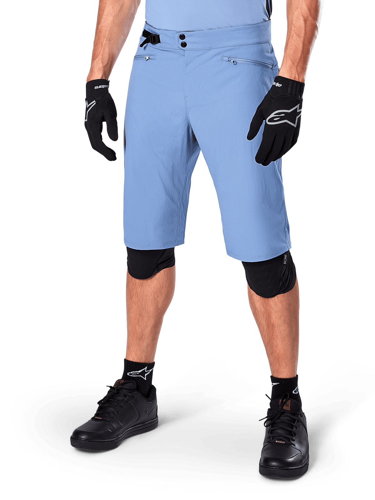 Alpinestars A-Dura Shorts, Infinity Blue, Mountain Bike Shorts, featuring zippered pockets and double snap closure, worn with black gloves and knee pads, durable 2-way stretch fabric for MTB