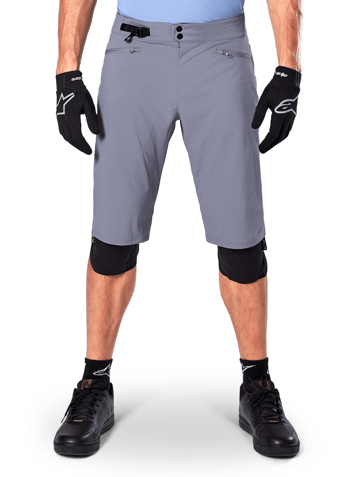 Alpinestars A-Dura Shorts, Mountain Bike Shorts, Dark Gray, worn with black Alpinestars gloves and knee pads, featuring double snap closure and zippered mesh-lined pockets, durable 2-way stretch fabric for off-road cycling