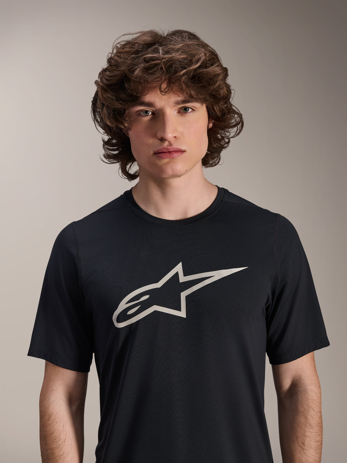 Alpinestars A-Dura Astar Short Sleeve Jersey, Black, featuring a large white Astar logo on the chest, worn by a male model, casual mountain bike performance apparel