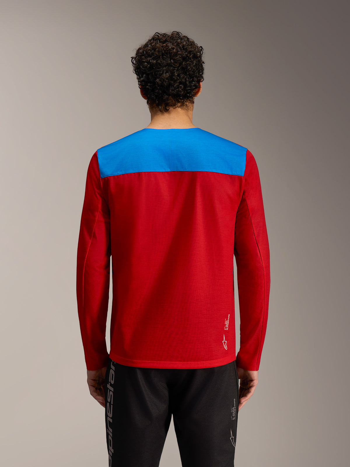 Maillot VTT A-Dura Elite 2.0 rouge et bleu à manches longues, logo Alpinestars blanc, vue de dos en studio.