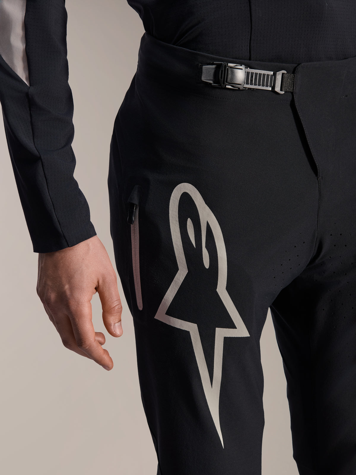 Alpinestars A-Supra Melt Pants, Mountain Bike Pants, Black, featuring a large white Astar logo on the thigh, adjustable ratchet waist closure, and side zippered pocket, detailed view of technical performance MTB gear