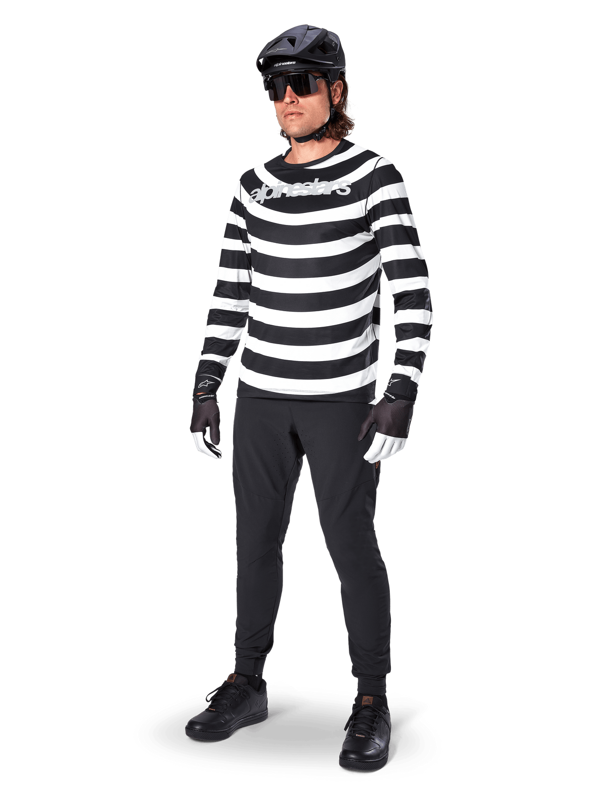 Alpinestars A-Aria Oscar Long Sleeve Jersey, Black and White with bold horizontal spiral stripes, white curved Alpinestars logo, performance MTB apparel worn with black cycling pants and helmet