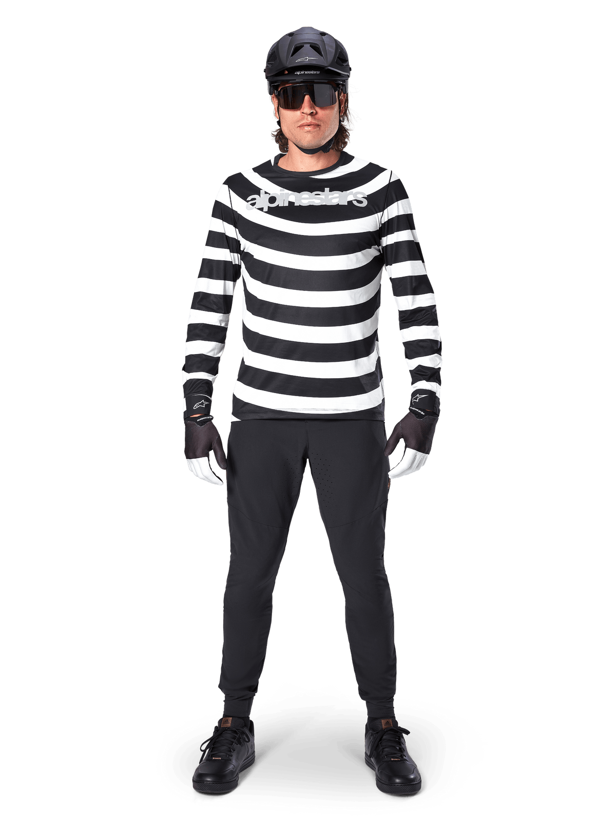 Alpinestars A-Aria Oscar Long Sleeve Jersey, MTB Jersey, Black and White horizontal stripes, worn with a black helmet and pants, featuring a vintage Oscar graphic and bold chest branding