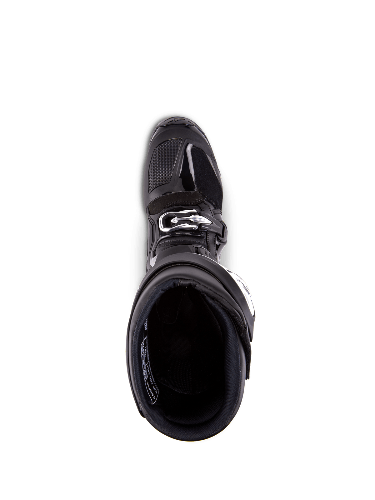 Bottes Alpinestars Tech 7, bottes de motocross, noir, vue de dessus sur la doublure intérieure, avec boucle de fermeture argentée et zone des orteils renforcée, équipement professionnel pour la course tout-terrain.