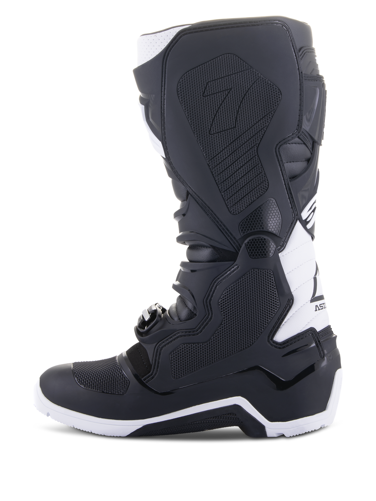 Alpinestars Tech 7 Enduro Drystar® Boots, Enduro Motorcycle Boots, Black and White, medial side view featuring honeycomb textured grip panels, TPU construction, and white accents on the heel and upper calf, professional off-road footwear