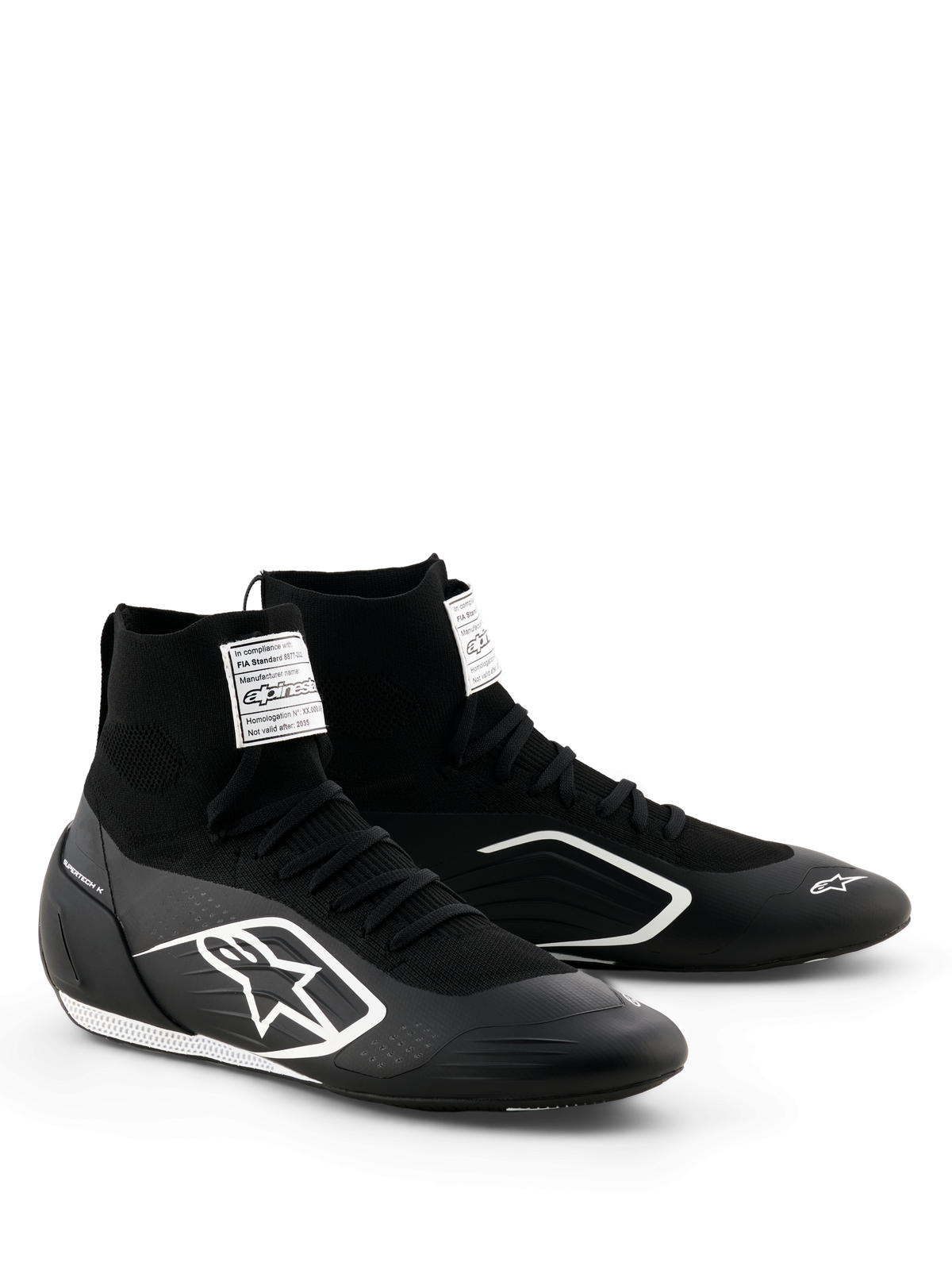 Alpinestars Supertech K Shoes - FIA, chaussures de karting, noir et blanc, tige entièrement tricotée avec coupe chaussette montante, logo Alpinestars blanc sur le côté, étiquette de certification FIA blanche sur la languette, design épuré et léger pour la performance en course