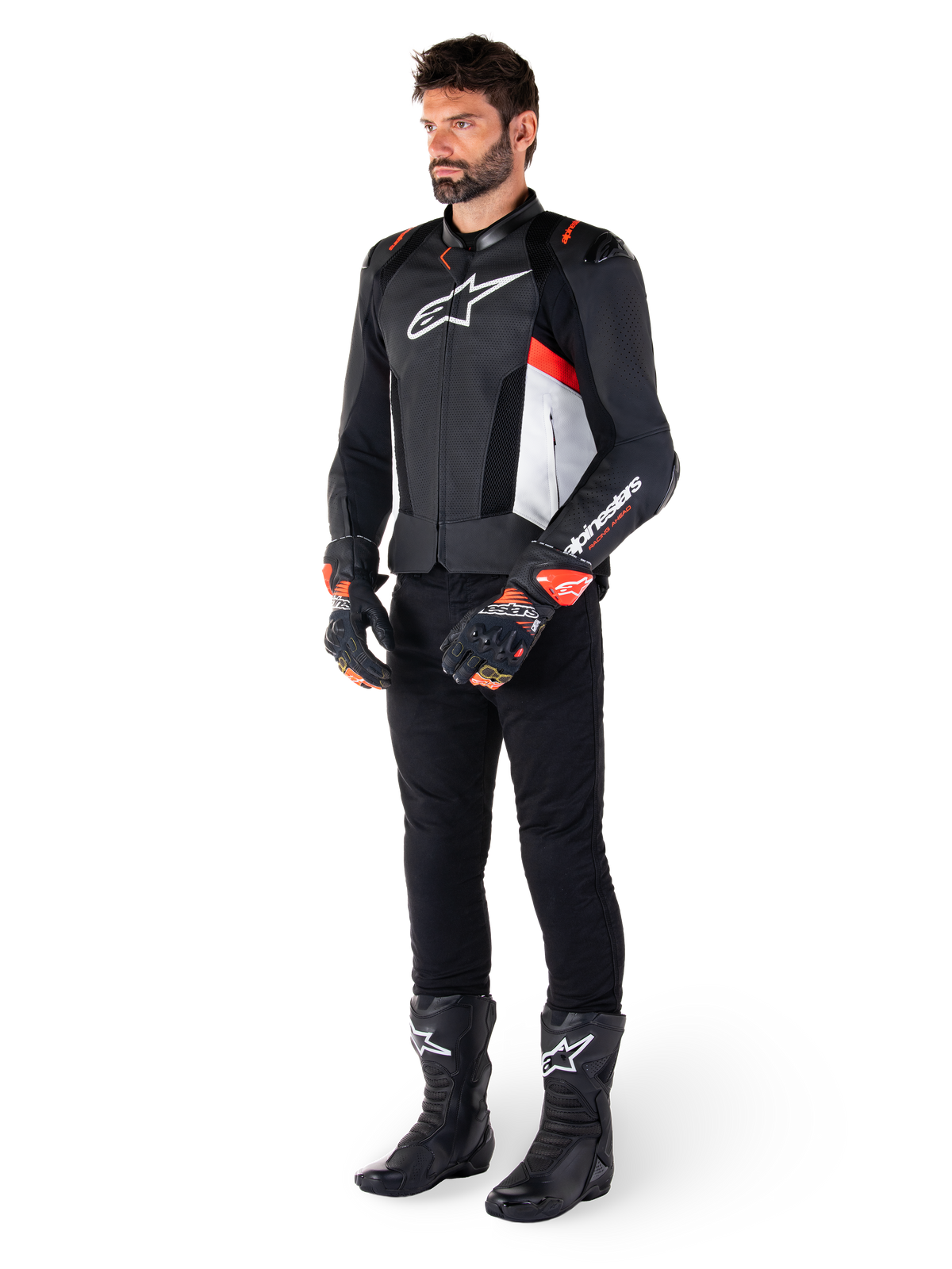 Veste en cuir Alpinestars Missile V3 Airflow, noir, blanc et rouge fluo, portée par un mannequin homme avec un pantalon noir, des gants de course noirs et des bottes noires, dotée de cuir perforé pour la ventilation, un logo blanc sur la poitrine et des accents rouge fluo, conçue pour une performance de course et de sport haut de gamme.
