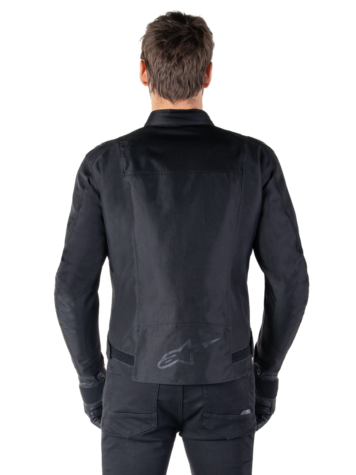 Alpinestars T-SPS V2 Waterproof Jacket, Black, back view showing the sport cut silhouette, reflective Alpinestars logo on the lower back, and extended back for extra coverage while riding.