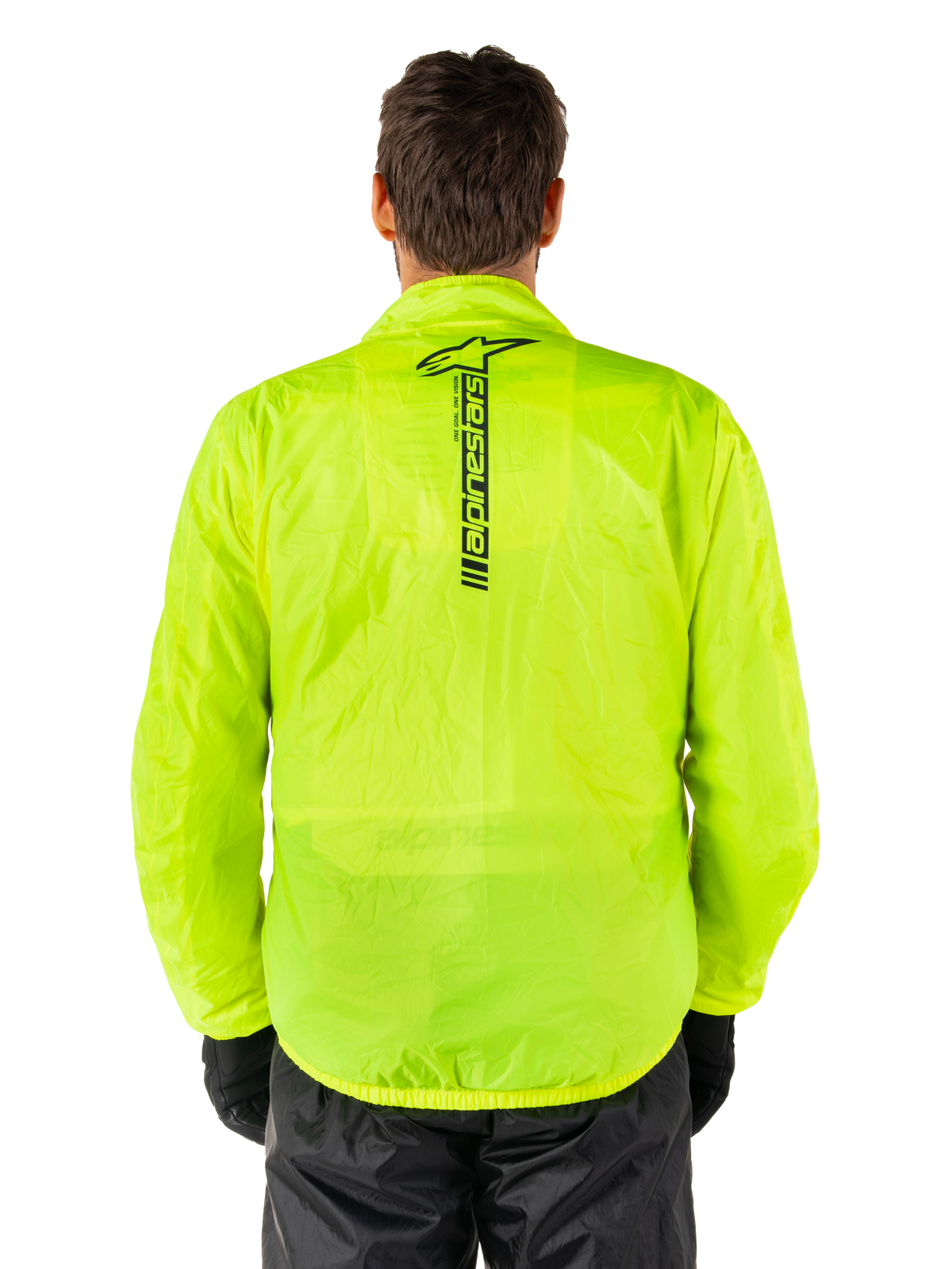Alpinestars Hurricane Rain V2 Jacket, Motorcycle Rain Jacket, Yellow Fluo, rear view showing vertical black Alpinestars logo on center back, lightweight waterproof fabric, worn with black riding pants and gloves