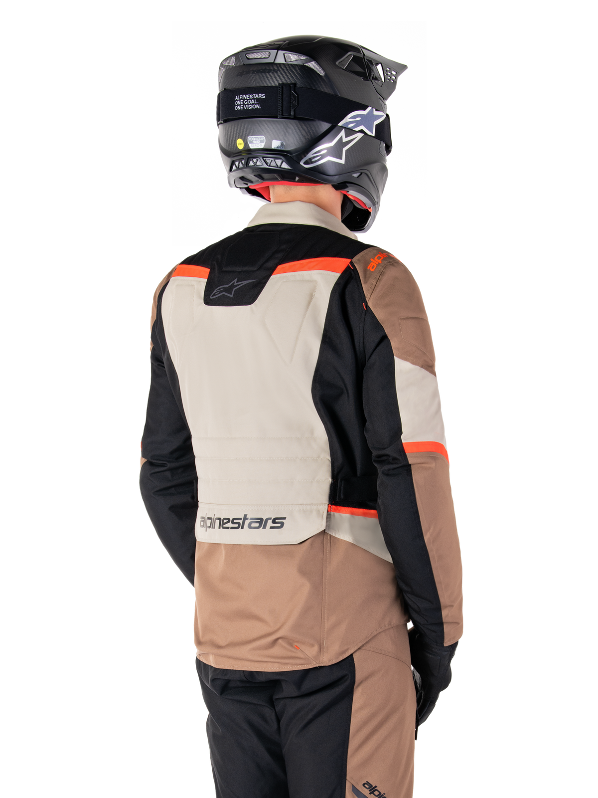 Alpinestars ST-1 Waterproof Jacket, Adventure Touring Jacket, Dark Khaki Sand Black Red Fluo, Back view showing color-blocked textile panels, fluorescent red accents, and Alpinestars branding on the lower back, worn by a rider with a black helmet.