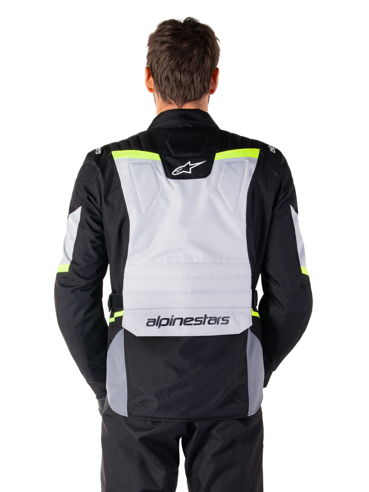 Alpinestars ST-1 Waterproof Jacket, Adventure Touring Jacket, Ice Gray Black and Yellow Fluo, back view on a model, featuring a light gray rear panel with Alpinestars logos, neon yellow accents, and streamlined protective design