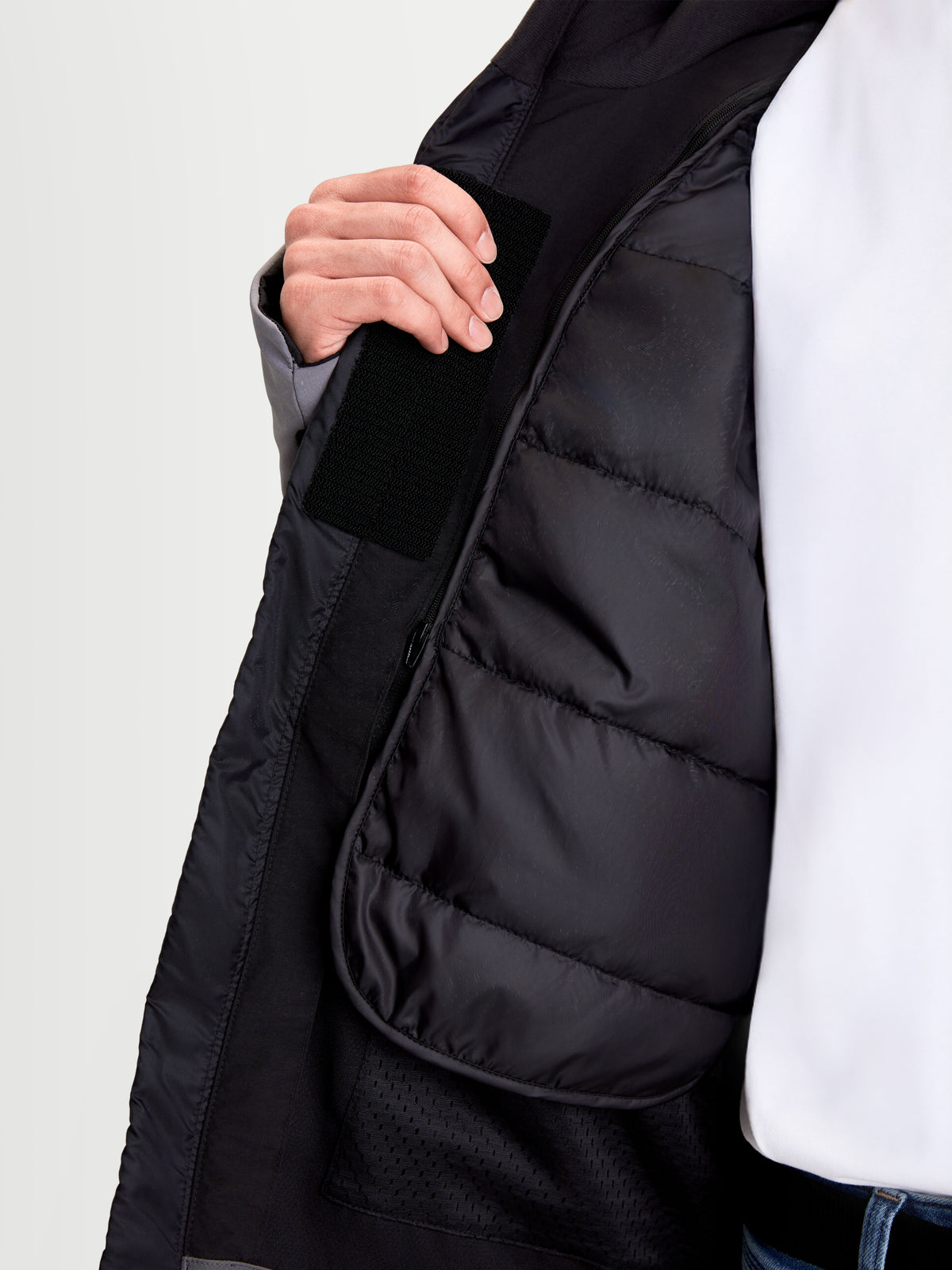 Alpinestars Therma-Tech Waterproof Jacket, men's urban motorcycle textile jacket, black and dark gray, close-up view showing internal sonic-welded down construction and thermal liner features.