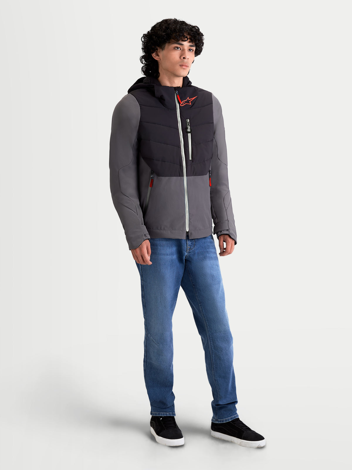 Alpinestars Therma-Tech Waterproof Jacket, men's urban contemporary motorcycle textile jacket in black and dark gray, front three-quarter view worn by a model with an integrated hood system and sonic-welded down construction.