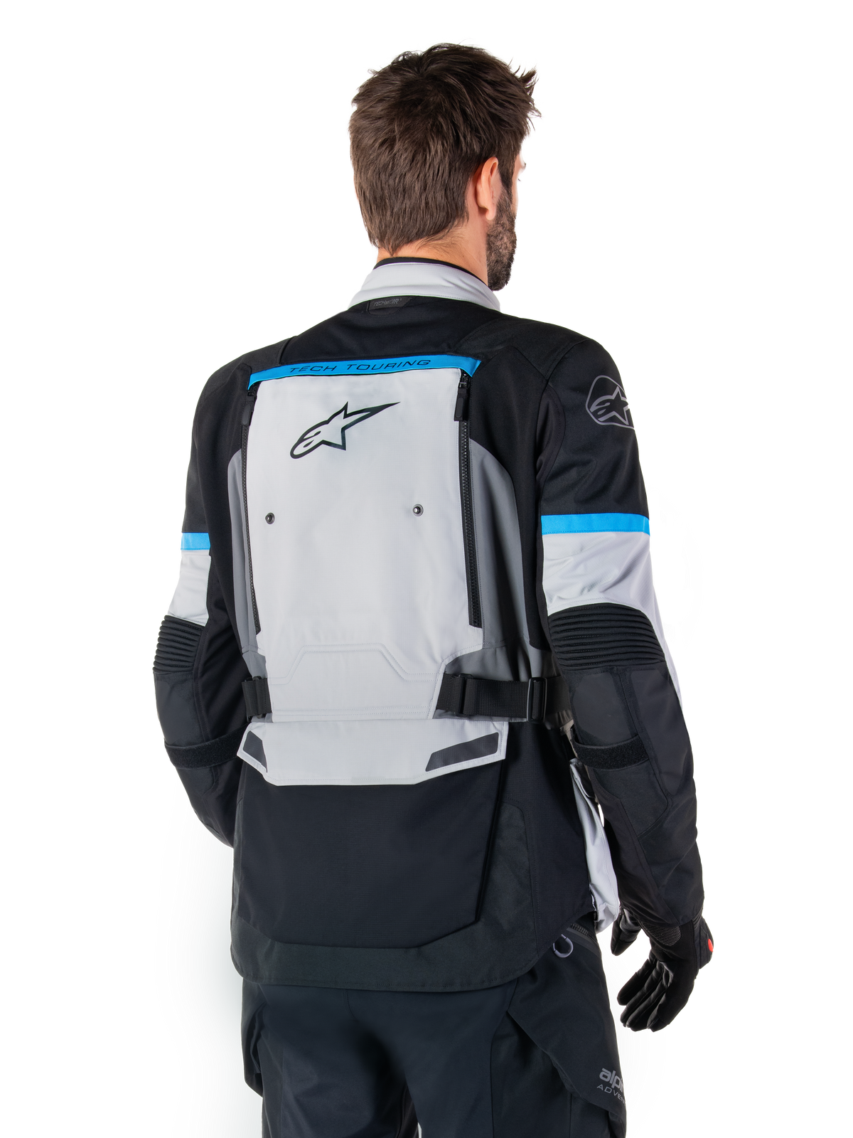 Veste Alpinestars Bogota' Pro Drystar®, veste de moto d'aventure pour homme, gris glacier et noire, vue arrière avec panneau Tech Touring et accents cyan.