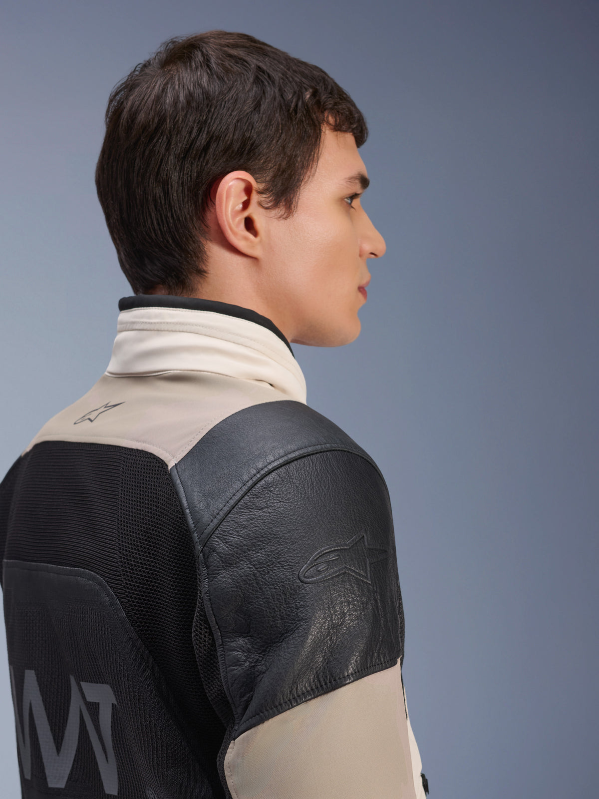 Veste Alpinestars AMT-10LAB Drystar® XF, veste de moto d'aventure, sable blanc et noir, profil latéral montrant l'épaule en cuir noir avec logo embossé, panneau arrière en maille MATYRX® avec logo AMT, conception modulaire protectrice toutes saisons.