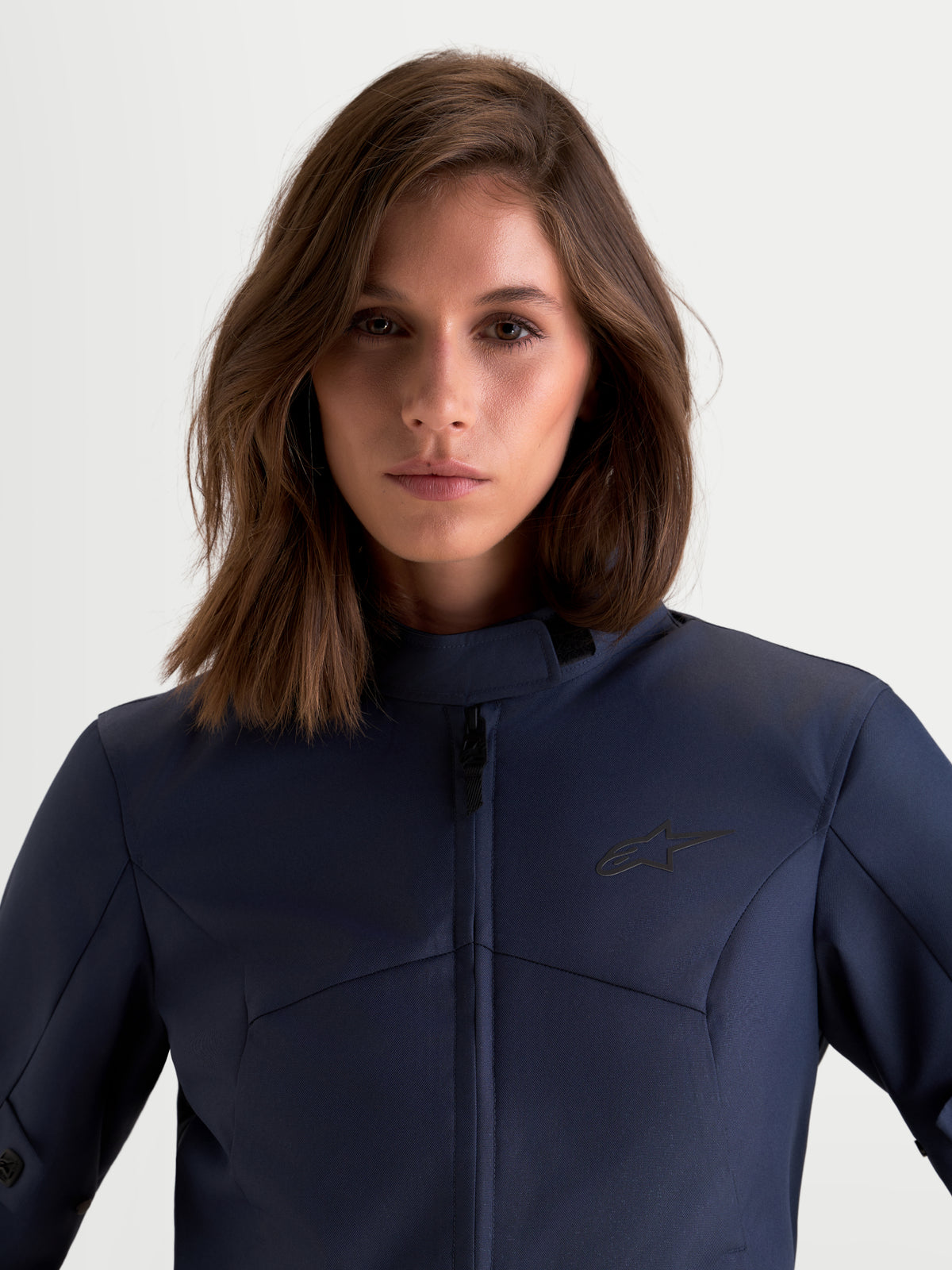 Alpinestars Stella C-1 Waterproof Jacket, women's urban motorcycle jacket in mood indigo blue, front close-up view showing textile construction and high collar worn by a model.