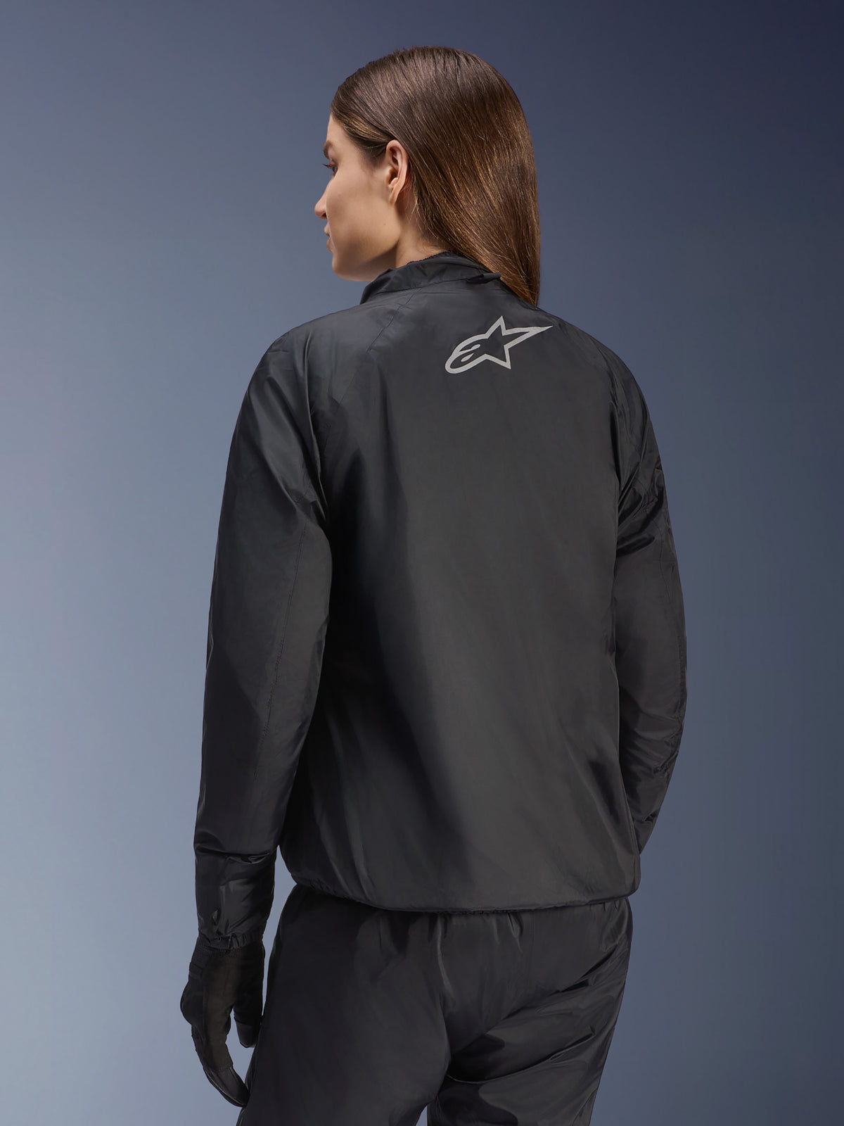 Alpinestars Stella Andes Air Drystar® Jacket, Women's Motorcycle Jacket, Black, rear view showing silver star logo, paired with black pants and gloves, lightweight waterproof touring gear