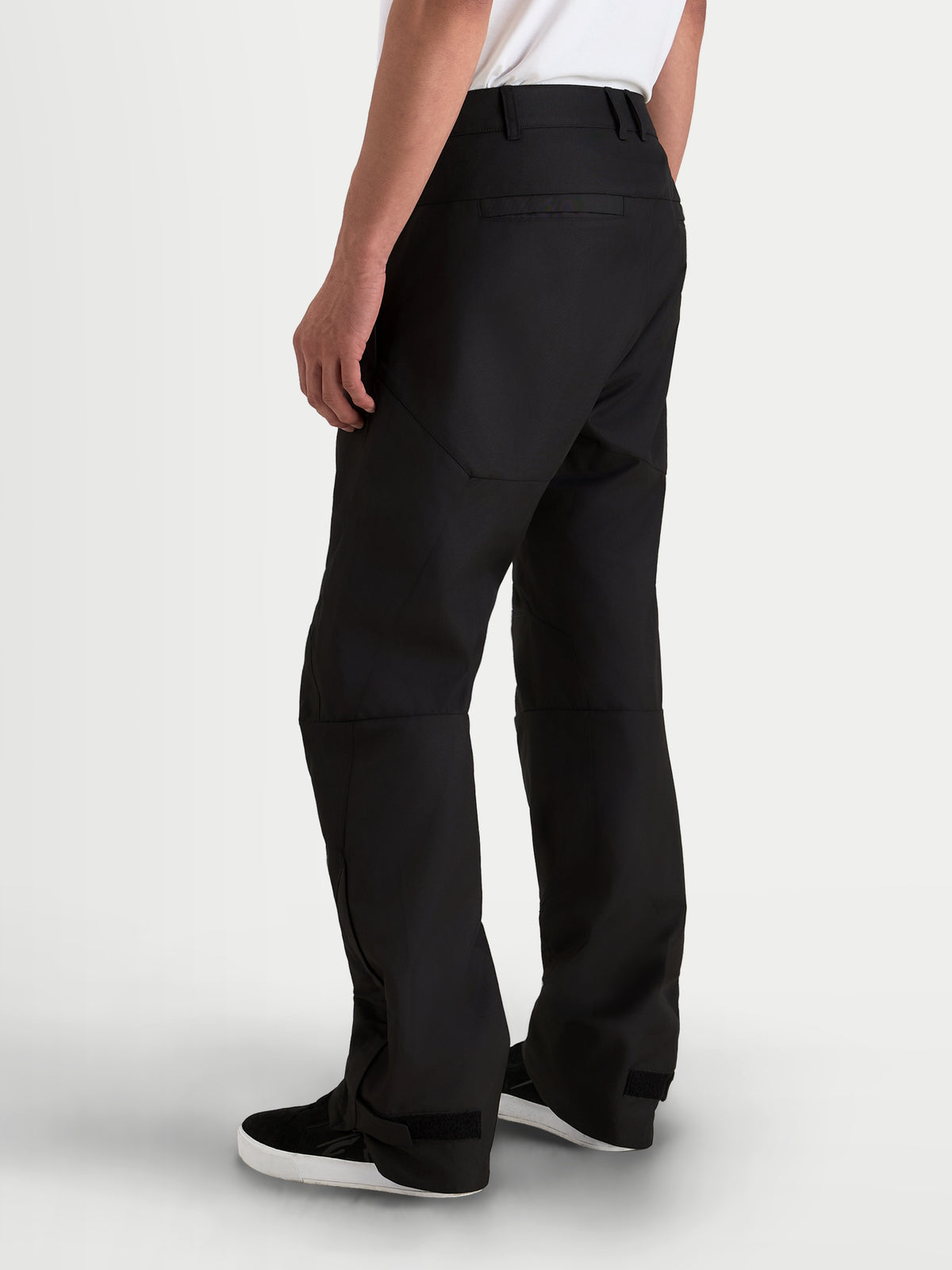 Alpinestars C-1 Waterproof Pants, men's urban contemporary motorcycle pants in black, rear three-quarter view showing durable 450D polyfabric shell construction and straight fit worn by a model.