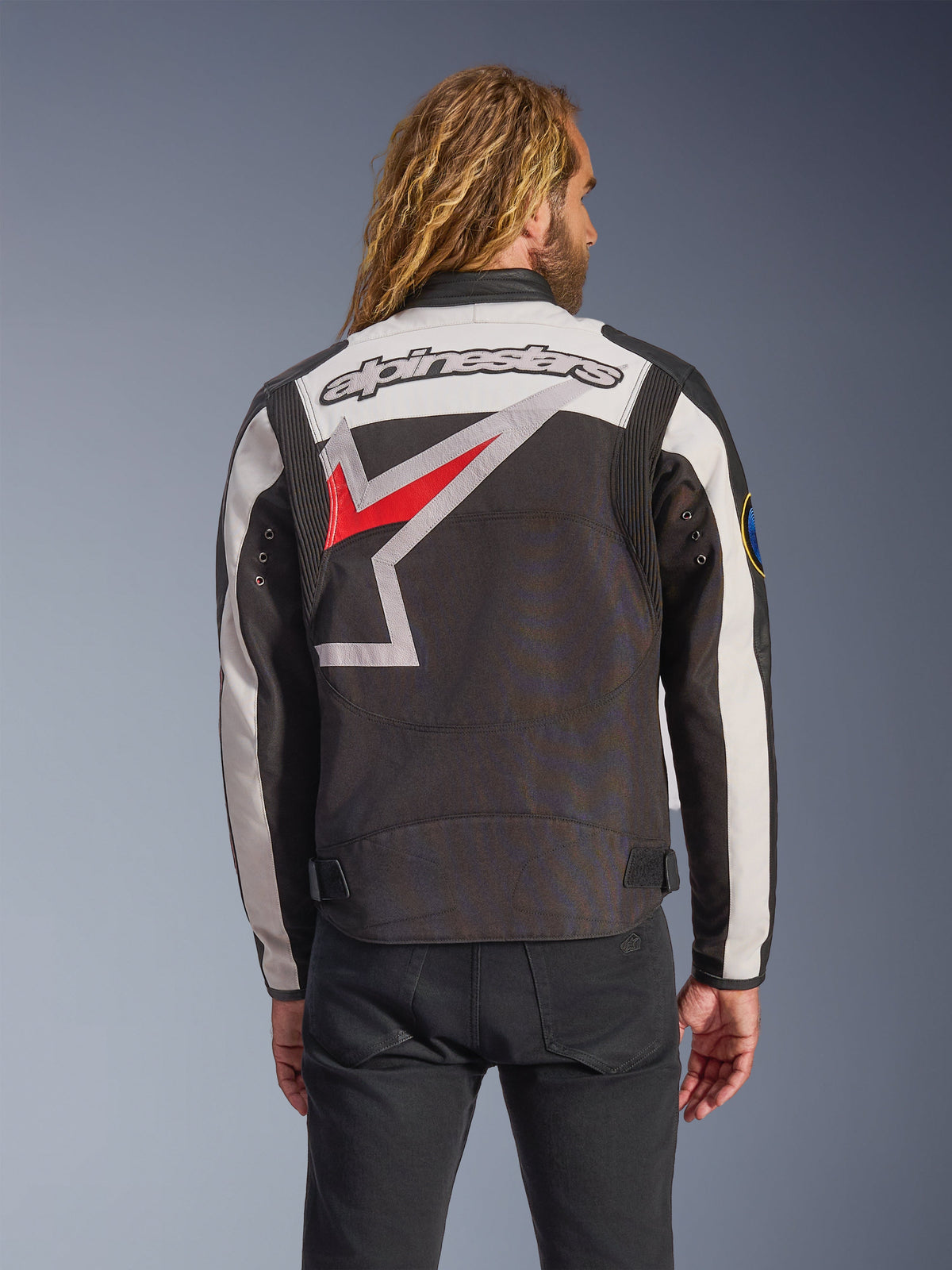 Alpinestars Axton Jacket, Motorcycle Jacket, Black Off White and Bright Red, back view featuring a large wrap-around star logo and wordmark, vintage racing-inspired design with accordion shoulder panels and waist adjusters