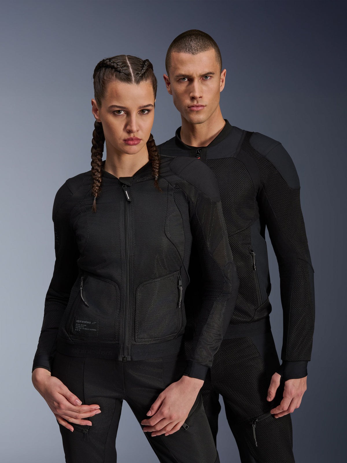 Alpinestars Troop-Air Pro Jacket, Black technical armored air jackets worn by male and female models, featuring breathable mesh panels and integrated protection, urban motorcycle gear designed for warm-weather riding.