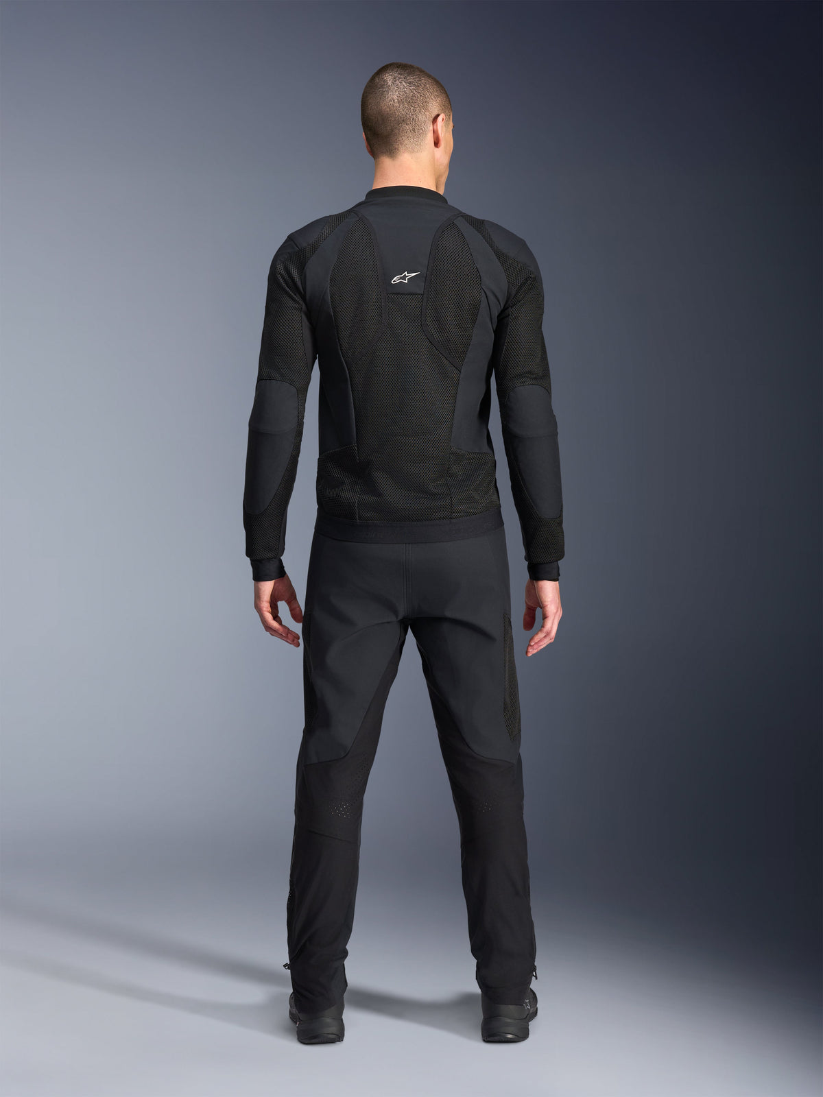 Alpinestars Troop-Air Pro Jacket, Back view, Black, technical motorcycle air jacket featuring large mesh ventilation panels and a white Alpinestars logo, paired with black pants, urban contemporary riding gear
