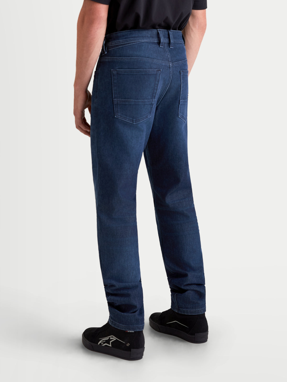 Alpinestars Flex-AST 10 Tough Max Denim Pants, men's motorcycle riding jeans in dark blue, rear view showing a model wearing the single-layer technical denim with AAA abrasion resistance and a traditional five-pocket layout