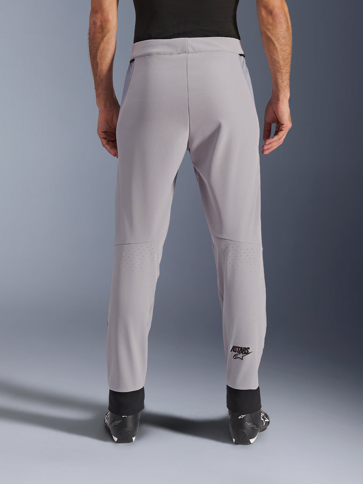 Alpinestars Aeroshell Airflow Pants, Motorcycle Pants, Mid Gray, back view showing laser-perforated zones on the calves and black Astars logo, textile softshell construction with black ankle cuffs and mesh hip panels.