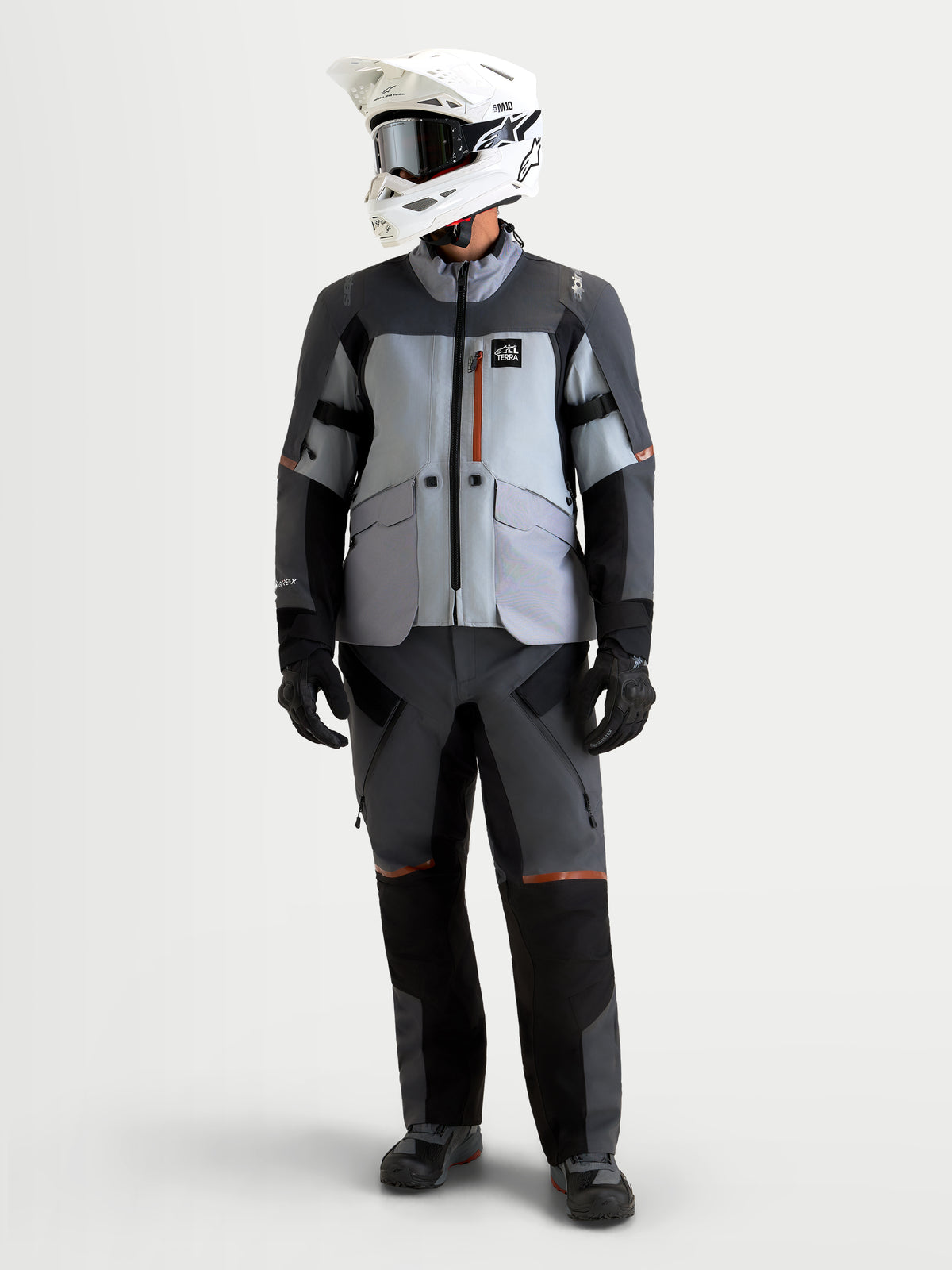 Alpinestars St-7 V2 2L Gore-Tex® Gear Set, men's adventure touring motorcycle jacket and pants in gray, dark gray, and black, front view on a model wearing matching waterproof textile riding apparel and helmet.