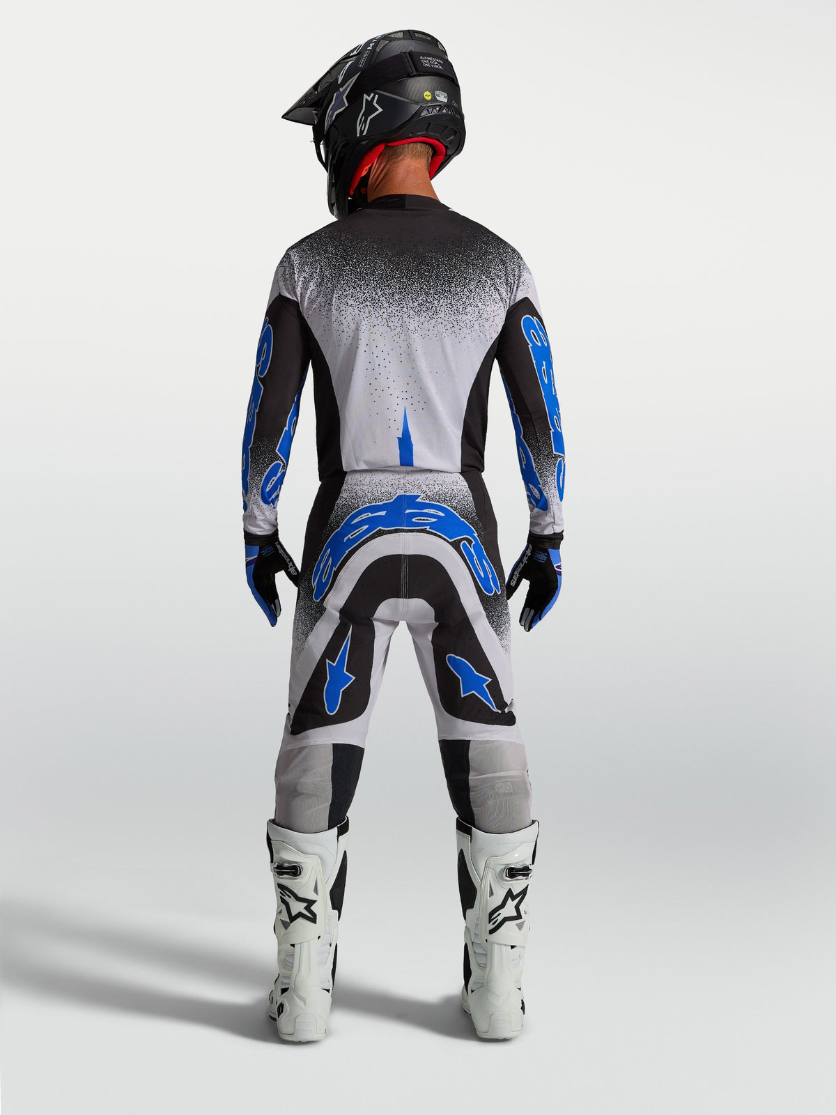 Pantalons Supertech Hiten AFD Alpinestars, équipement de motocross pour homme, bleus et blancs, vue de dos athlétique.