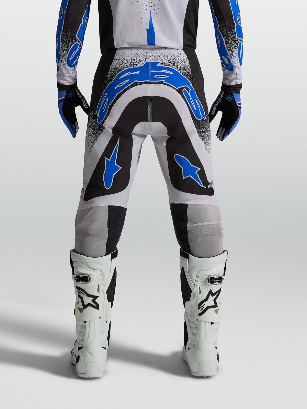Alpinestars Supertech Hiten AFD, pantalons de motocross homme, bleus, noirs et blancs, coupe athlétique, vus de dos.