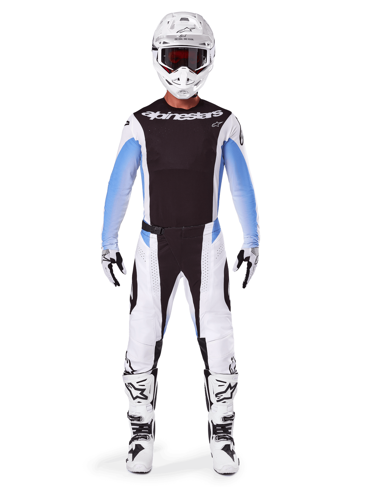Pilote de motocross portant le pantalon Alpinestars Techstar Melt 2025, pantalon de motocross, noir et bleu, design multi-panneaux blanc et noir avec des accents bleus sur les hanches, porté avec un maillot blanc assorti, un casque blanc, des gants blancs et des bottes pour un équipement de course tout-terrain complet