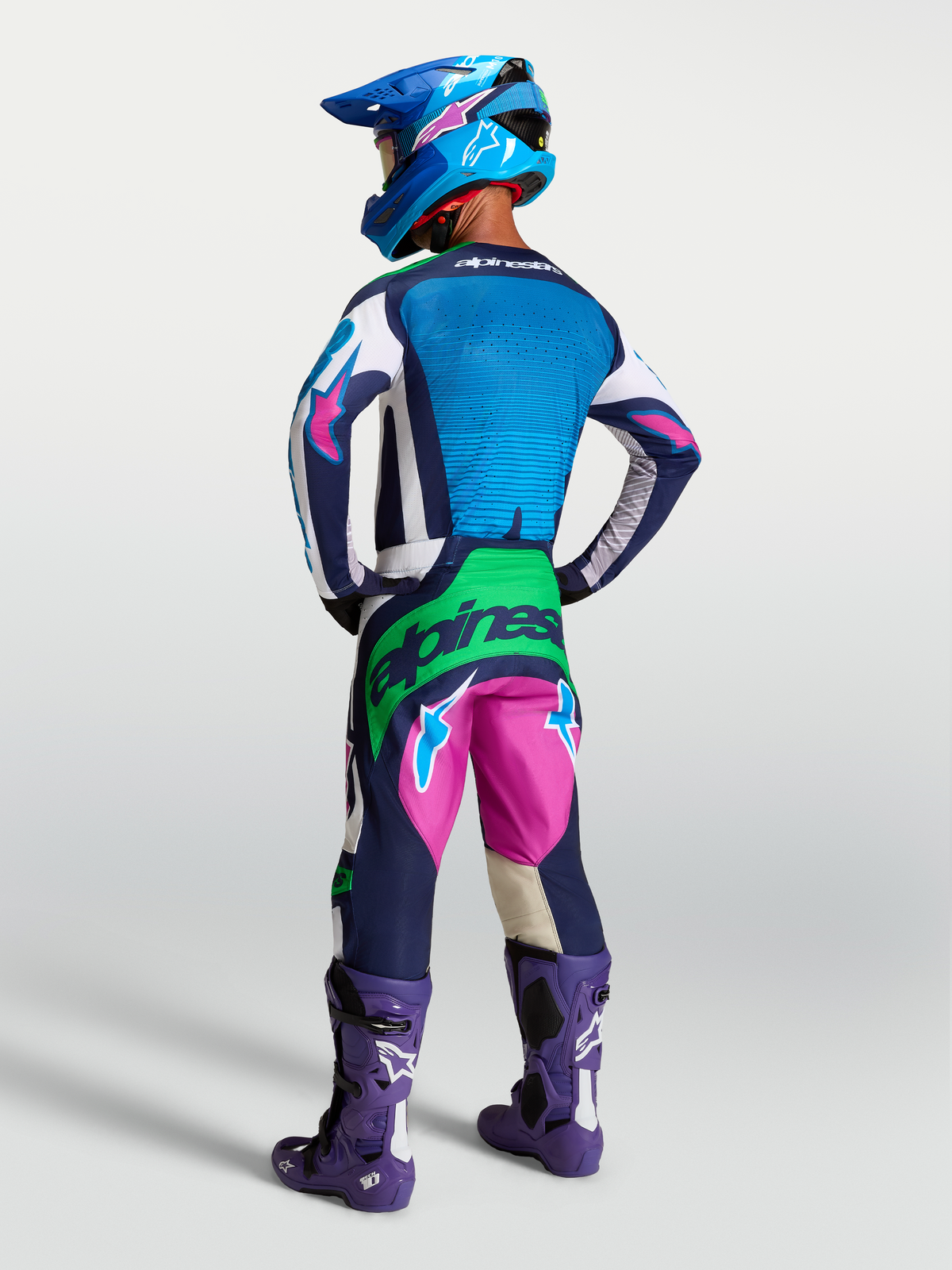Alpinestars Techstar Maven Gear Set, blue and pink motocross racing kit with green fluo accents, on-model rear view.