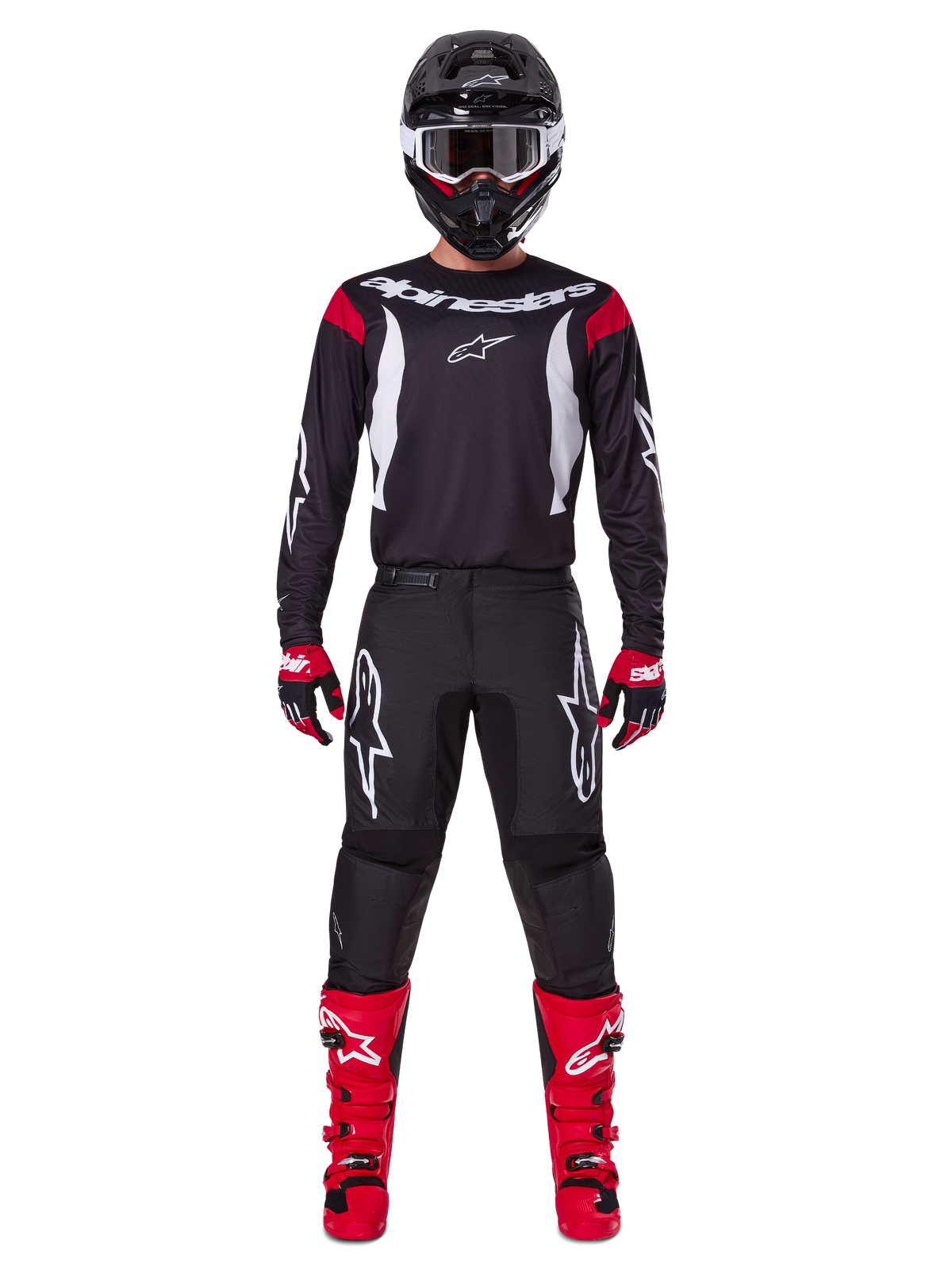 Ensemble d'équipement Alpinestars 2025 Fluid Haul, pilote de motocross en tenue de course complète, maillot noir avec accents rouges aux épaules et logos blancs, pantalon noir avec logo étoile blanc, bottes rouge vif, gants rouges et noirs, casque noir avec lunettes blanches, look de performance tout-terrain coordonné
