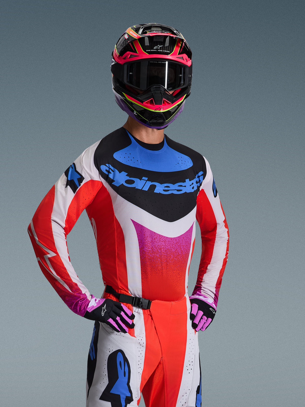 Alpinestars 2026 Techstar Knif Gear Set, Motocross racing gear, White and red jersey with pink gradient and blue accents, matching white and red pants, pink and black helmet with dark goggles, black and pink gloves, coordinated outfit for off-road performance