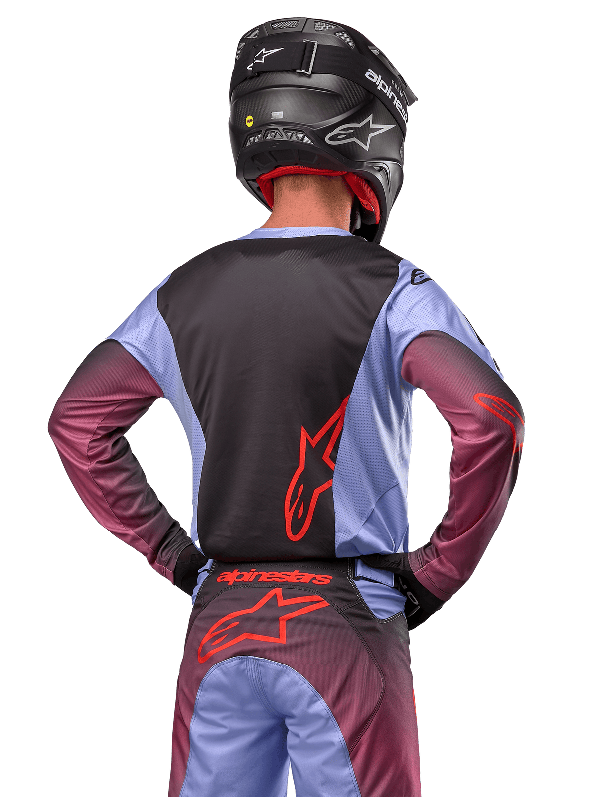 Motocross rider from the back wearing Alpinestars 2024 Racer Hoen gear, Lavan Purple and Black jersey with red logo, matching pants with red accents, black helmet, coordinated outfit for off-road racing