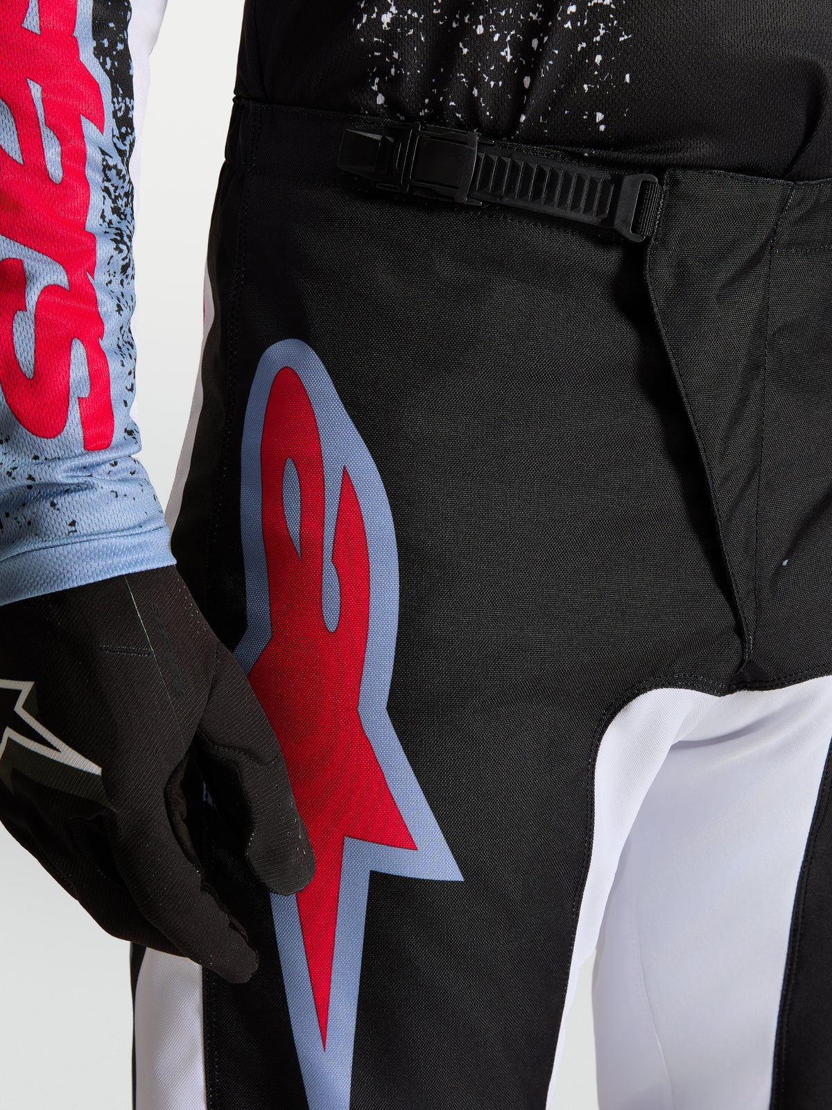 Alpinestars Fluid Drag Pants, Black and Red Men's Motocross Pants, featuring a ratchet waist closure and large graphic logo.