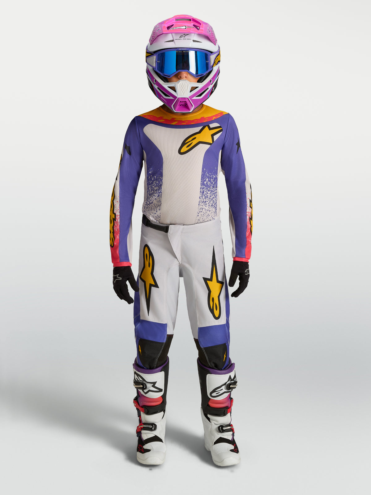 Pantalon Fluid Drag Junior Alpinestars, ensemble de motocross violet et blanc avec accents dorés pour enfant.