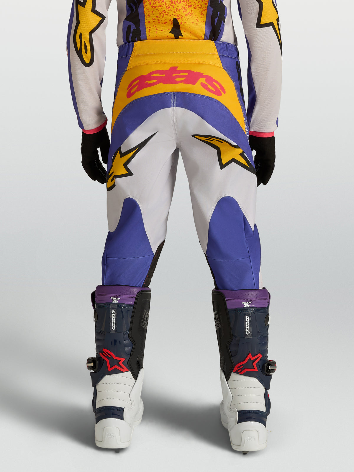 Alpinestars pantalon Fluid Drag junior, pantalon de motocross bleu et doré, construction 600D durable, étoiles, vue de dos.