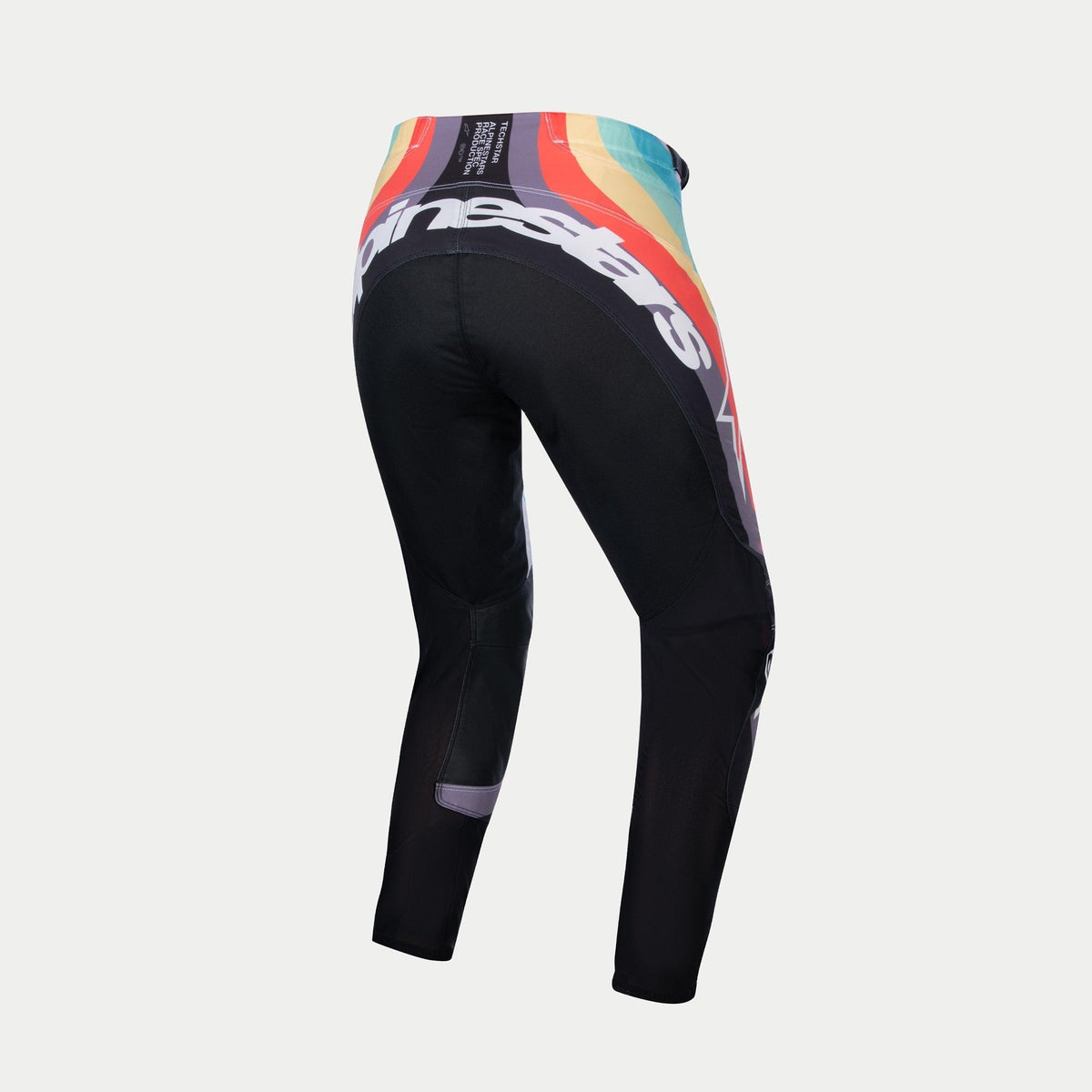 Alpinestars Stella Techstar Pants 2024 pour femme, pantalon de motocross, noir multicolore, vue arrière présentant un motif de vagues éclatant en rouge, orange et bleu à la taille, grand logo Alpinestars blanc à l'arrière, conçu pour la course tout-terrain