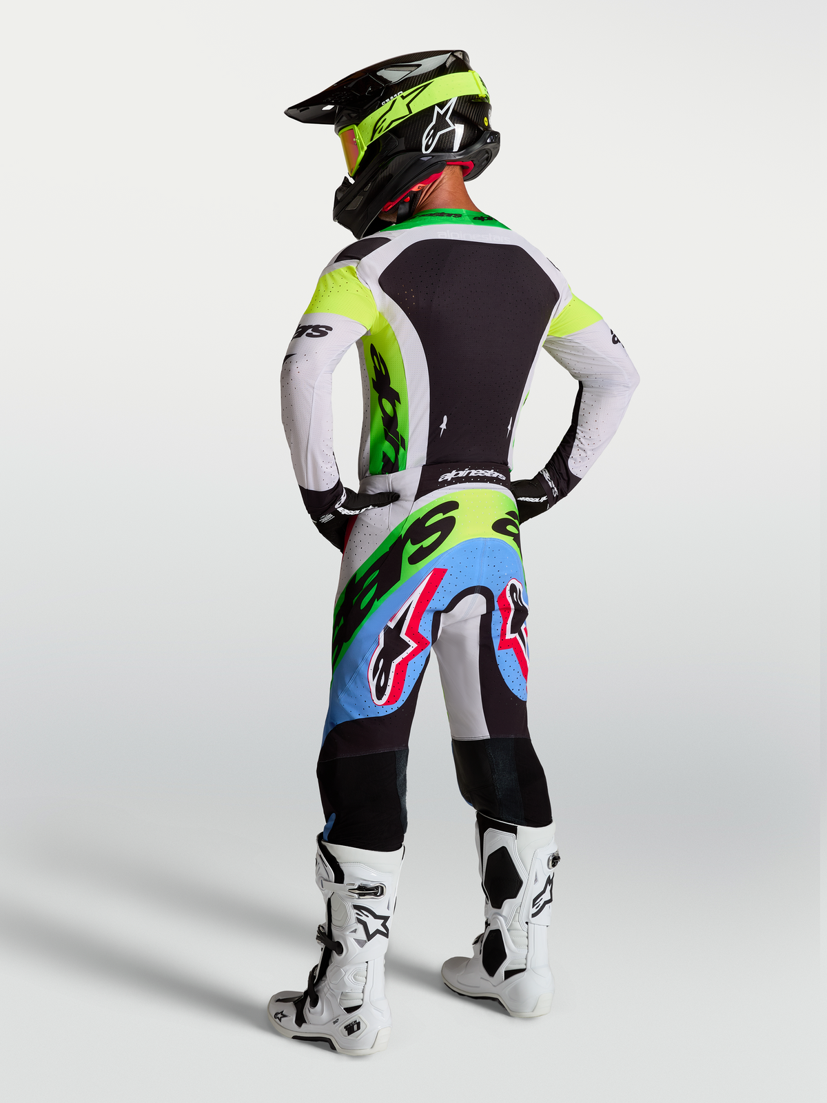 Alpinestars Supertech Dyna Jersey and Gear Set, men's motocross gear in green fluo and lilac, rear view.