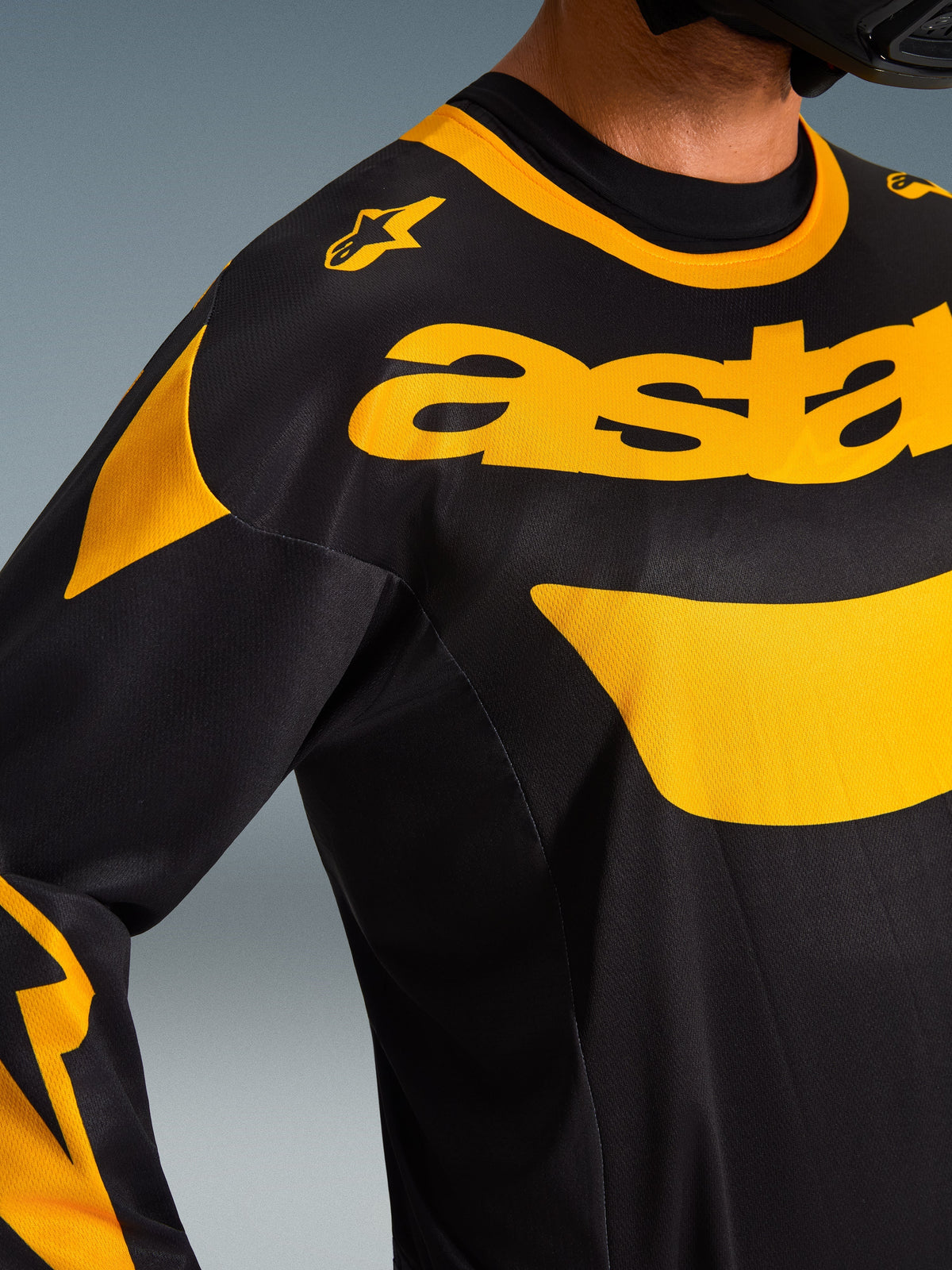 Maillot Alpinestars Racer Riway 2026, maillot de motocross, jaune et noir, gros plan sur la poitrine et l'épaule, logo 'astars' jaune vif et accents graphiques sur poly-tissu noir, équipement tout-terrain haute performance