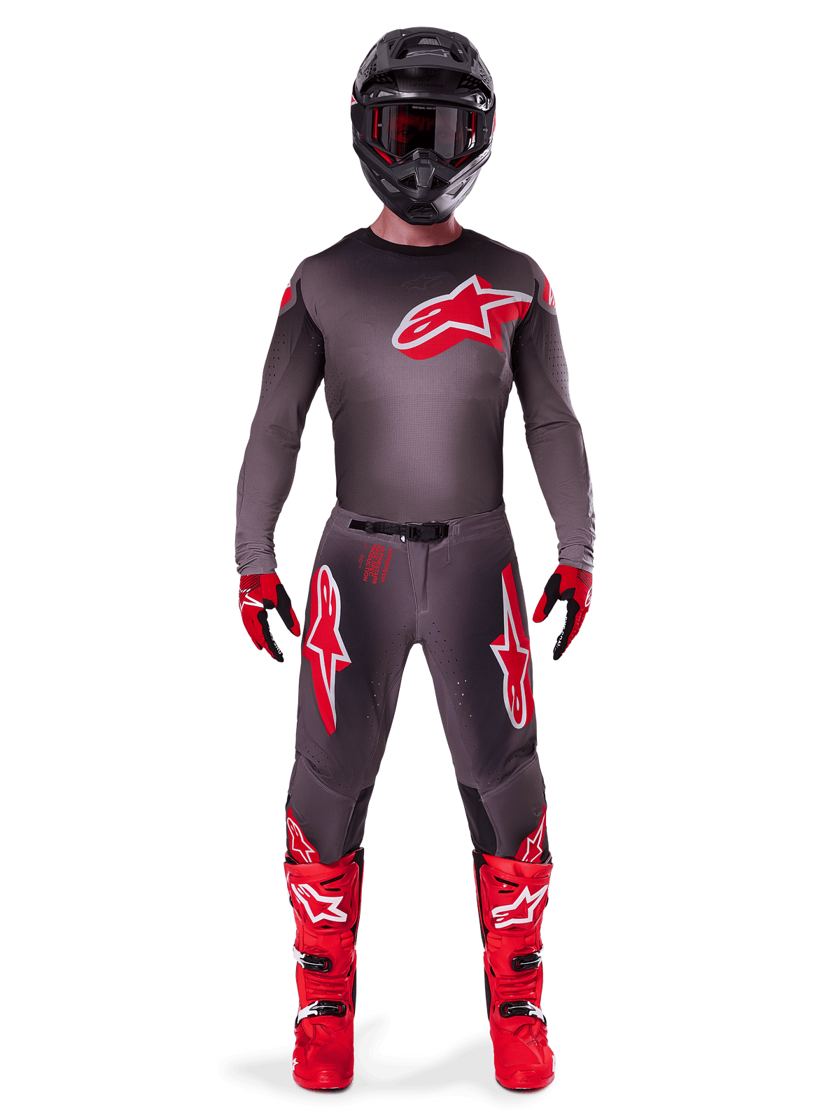 Motocross rider wearing Alpinestars 2025 Supertech Lipan Gear Set, Smoke and Bright Red, dark grey jersey and pants with bold red Alpinestars logos, bright red boots, black helmet, and red gloves, coordinated professional outfit for off-road racing