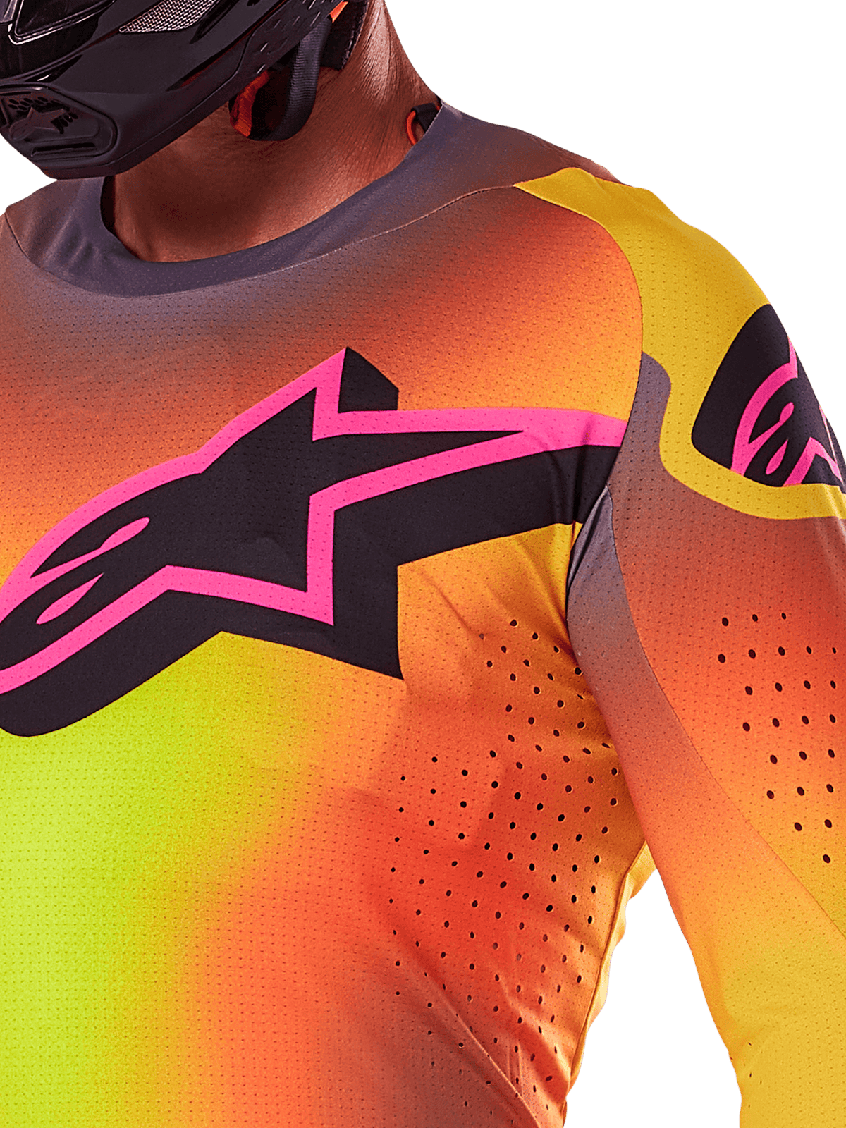 Gros plan sur le maillot Alpinestars Supertech Lipan 2025 en Jaune Rose, présentant un design en dégradé éclatant, un grand logo étoile noir avec une bordure rose sur la poitrine et des perforations découpées au laser visibles pour une meilleure circulation de l'air.